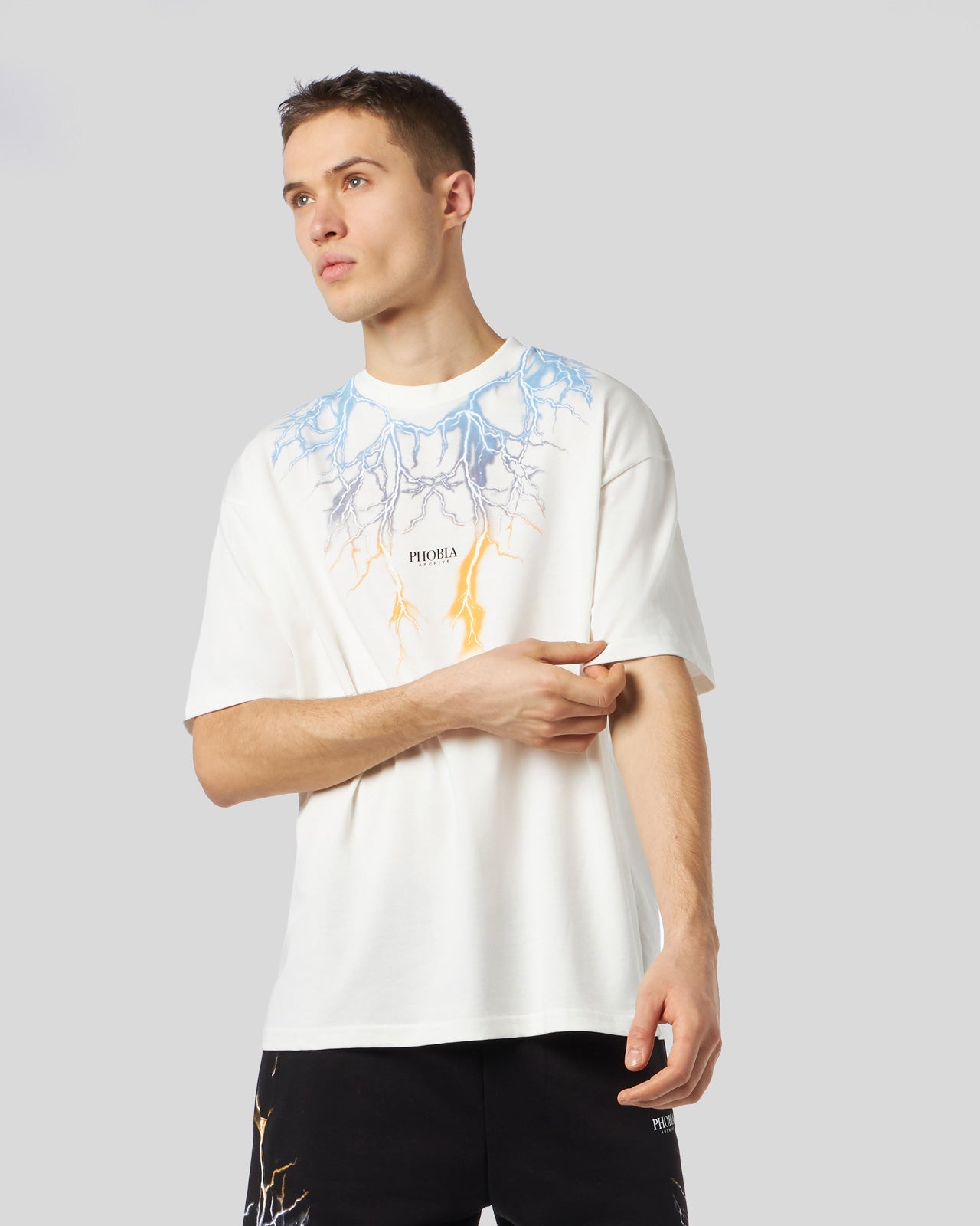 WHITE T-SHIRT WITH BICOLOR BLUE-YELLOW LIGHTNING PRINT