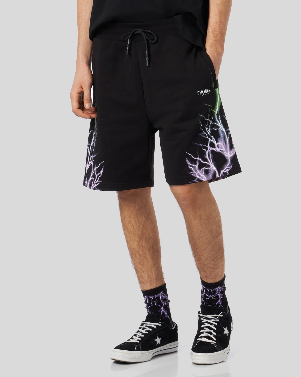 BLACK SHORTS WITH BICOLOR PURPLE-GREEN LIGHTNING PRINT