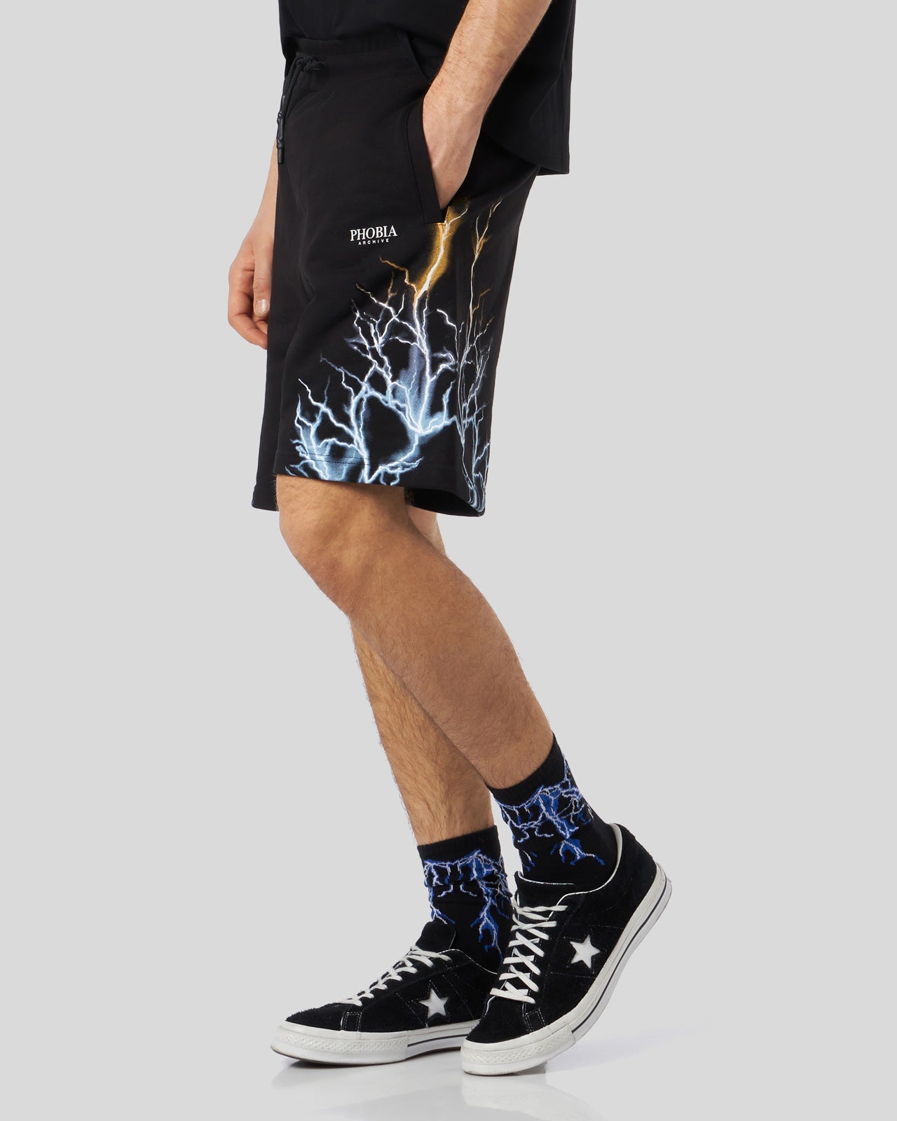 BLACK SHORTS WITH BICOLOR BLUE-YELLOW LIGHTNING PRINT