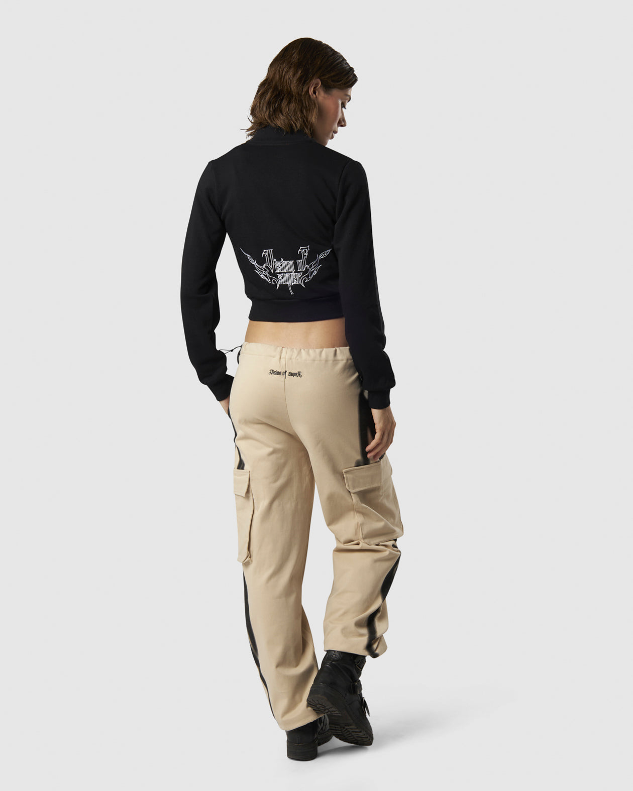 BLACK LONGSLEEVE ZIP WITH EMBROIDERED LOGO ON FRONT AND EMBROIDERED TRIBAL GRAPHIC ON BACK